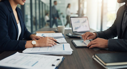two people meeting looking at business records