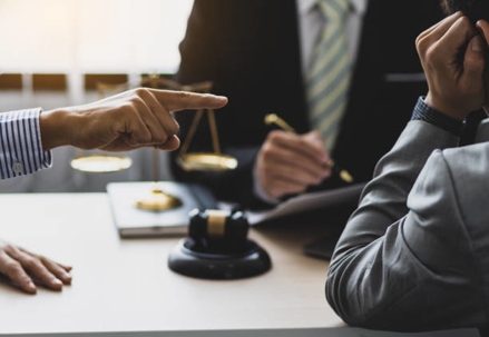 Meeting at law office, man pointing finger at person