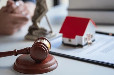 Gavel and a house on a paper