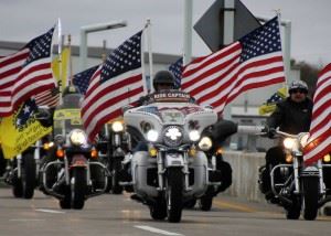 Leading the motor coaches from the BWI Airport to the World War II Memorial are Patriot Guard Riders. Veterans are greeted by community well-wishers, other military members and Annapolis midshipmen.