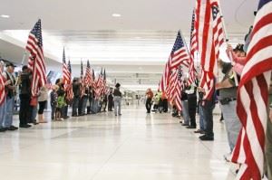 The Patriot Guard Riders greet each Honor Flight mission at the Rochester Airport on their return, welcoming them through a tunnel of flags.